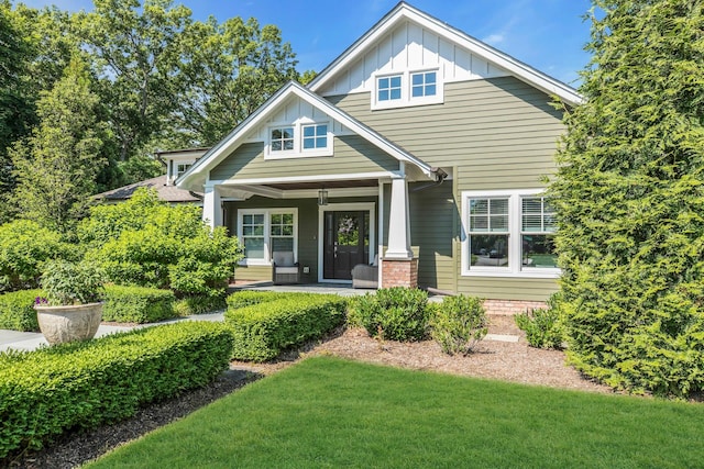 120 Cambon Ave, Saint James, NY 11780 - view of front of house featuring board and batten siding, a porch, and a front yard