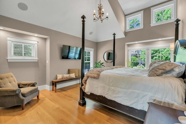120 Cambon Ave, Saint James, NY 11780 - bedroom with light wood finished floors, multiple windows, a chandelier, and a high ceiling