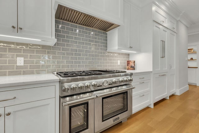 120 Cambon Ave, Saint James, NY 11780 - kitchen featuring range with two ovens, custom range hood, light wood-style flooring, white cabinetry, and ornamental molding