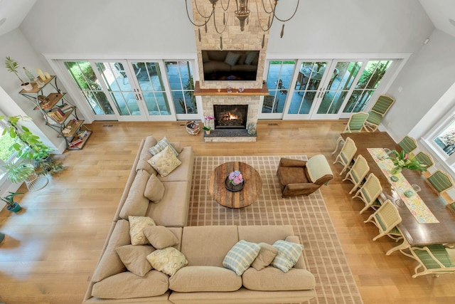 120 Cambon Ave, Saint James, NY 11780 - living area featuring wood finished floors, high vaulted ceiling, and a fireplace