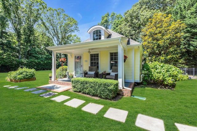 120 Cambon Ave, Saint James, NY 11780 - view of front facade with a front yard, covered porch, a ceiling fan, and outdoor lounge area