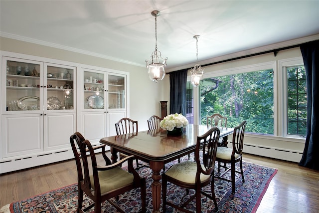 100 Gristmill Ln, Manhasset, NY 11030 - dining space with baseboard heating, crown molding, and wood finished floors