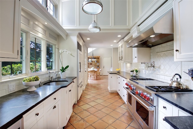 100 Gristmill Ln, Manhasset, NY 11030 - kitchen with range with two ovens, dark countertops, plenty of natural light, white cabinetry, and recessed lighting