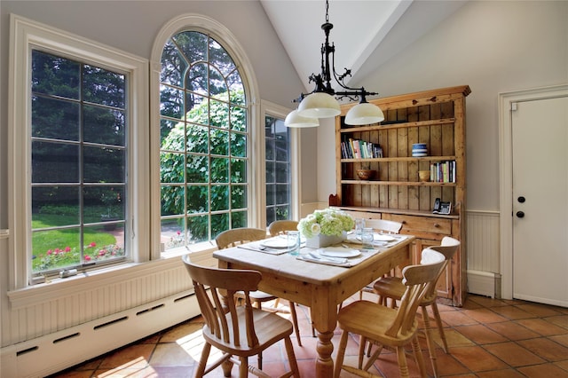 100 Gristmill Ln, Manhasset, NY 11030 - tiled dining area with a baseboard heating unit, vaulted ceiling, a chandelier, and wainscoting