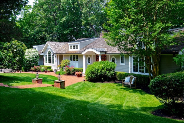 100 Gristmill Ln, Manhasset, NY 11030 - view of front of house featuring a front lawn and a chimney