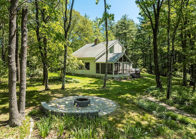 66 Beacon Hill Rd, Call Listing Agent, NY 12060 - view of green lawn featuring a sunroom and an outdoor fire pit