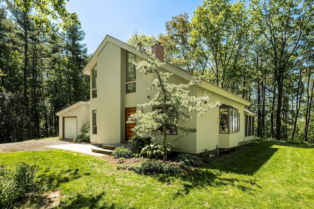 66 Beacon Hill Rd, Call Listing Agent, NY 12060 - view of side of home with a chimney, a lawn, driveway, and an attached garage