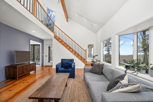 66 Beacon Hill Rd, Call Listing Agent, NY 12060 - living area with rail lighting, wood-type flooring, plenty of natural light, high vaulted ceiling, and stairs