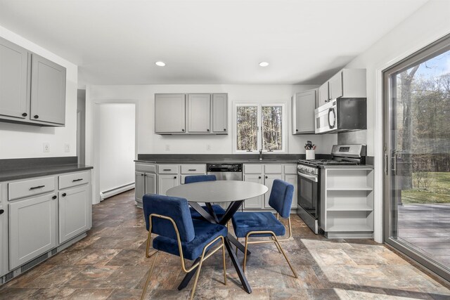 66 Beacon Hill Rd, Call Listing Agent, NY 12060 - kitchen with appliances with stainless steel finishes, dark stone finish floors, dark countertops, baseboard heating, and recessed lighting