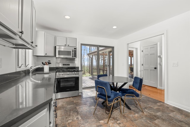 66 Beacon Hill Rd, Call Listing Agent, NY 12060 - kitchen featuring stainless steel appliances, a sink, dark stone finish floors, recessed lighting, and baseboards