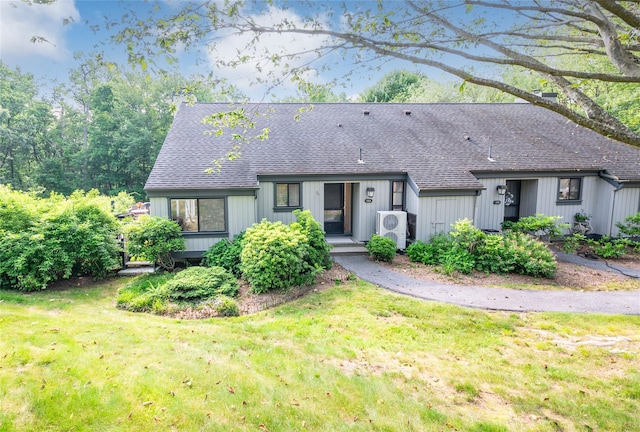 331 Heritage Hls Unit A, Somers, NY 10589 - view of front of house featuring roof with shingles, a front lawn, and a cooling unit