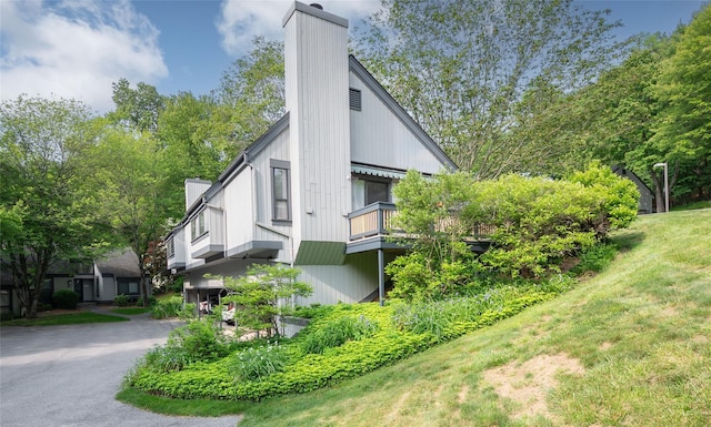 331 Heritage Hls Unit A, Somers, NY 10589 - view of side of property featuring a chimney, a balcony, and a yard