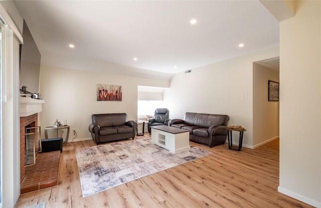 331 Heritage Hls Unit A, Somers, NY 10589 - living room with light wood-style flooring, a brick fireplace, baseboards, and recessed lighting