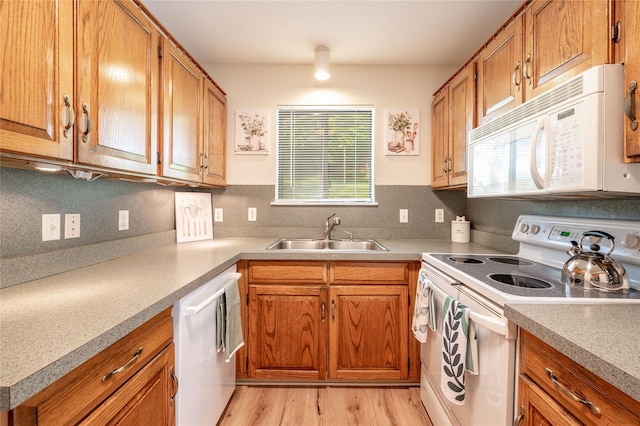 331 Heritage Hls Unit A, Somers, NY 10589 - kitchen featuring white appliances, a sink, brown cabinetry, and light countertops