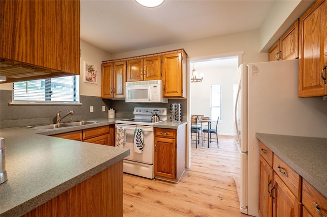 331 Heritage Hls Unit A, Somers, NY 10589 - kitchen with white appliances, a sink, light wood finished floors, tasteful backsplash, and brown cabinets