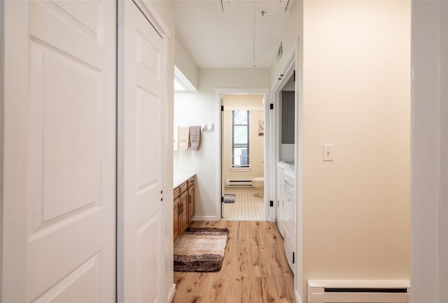 331 Heritage Hls Unit A, Somers, NY 10589 - corridor with attic access, a baseboard radiator, light wood-style floors, and baseboards