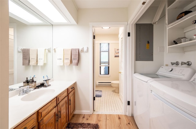 331 Heritage Hls Unit A, Somers, NY 10589 - bathroom featuring a baseboard radiator, electric panel, vanity, wood finished floors, and toilet