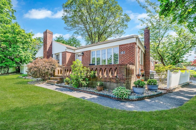 191 Laurel Rd, East Northport, NY 11731 - view of front of house featuring a chimney and brick siding