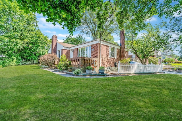 191 Laurel Rd, East Northport, NY 11731 - rear view of property with a chimney and brick siding