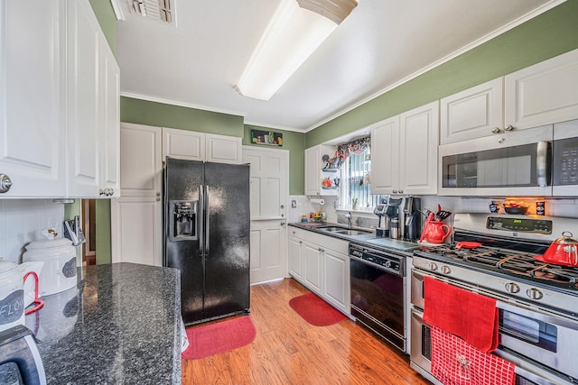 191 Laurel Rd, East Northport, NY 11731 - kitchen with black appliances, white cabinetry, light wood-type flooring, ornamental molding, and a sink