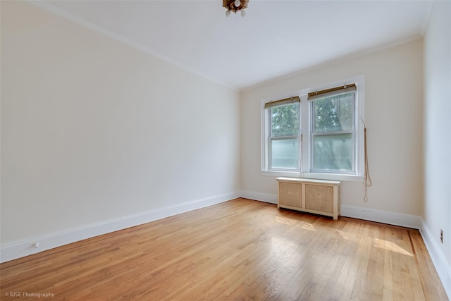 3916 51st St, Woodside, NY 11377 - spare room with hardwood / wood-style floors, ornamental molding, and radiator