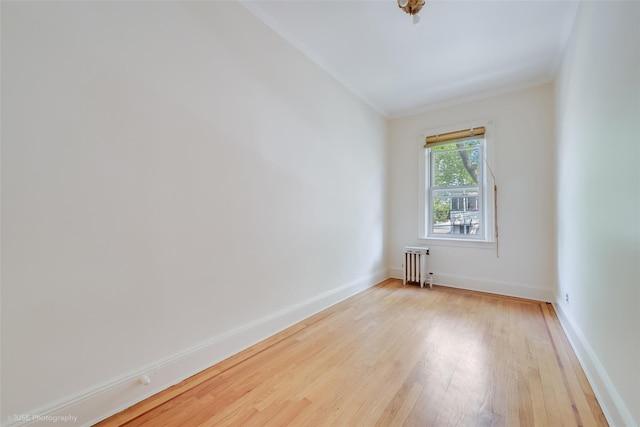 3916 51st St, Woodside, NY 11377 - empty room with radiator heating unit and light wood finished floors