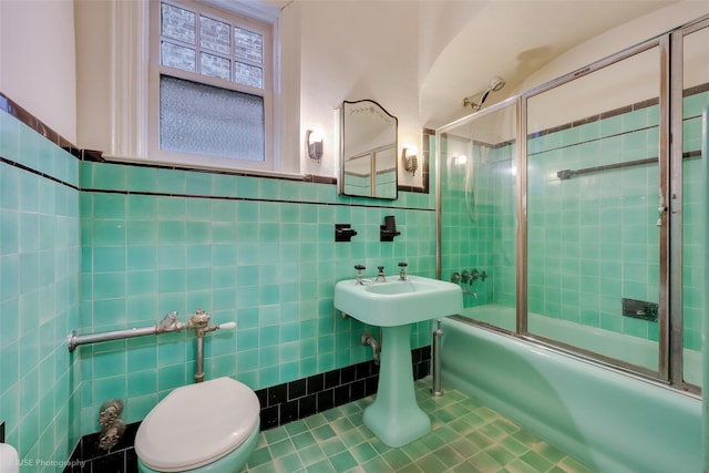 3916 51st St, Woodside, NY 11377 - full bath featuring tile walls, bath / shower combo with glass door, and tile patterned floors