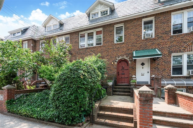 3916 51st St, Woodside, NY 11377 - view of front facade with entry steps, brick siding, and a high end roof
