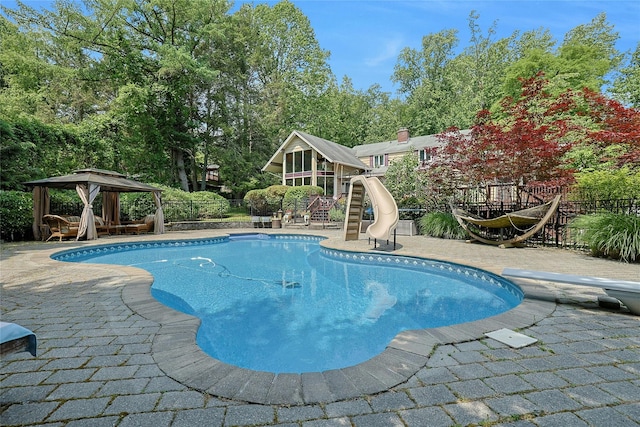 9 Van Houten Flds, West Nyack, NY 10994 - view of swimming pool featuring a gazebo, a water slide, a diving board, view of scattered trees, and a patio