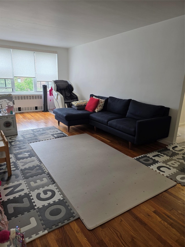 18-50 211th St Unit 6C, Bayside, NY 11360 - living room with radiator and wood finished floors