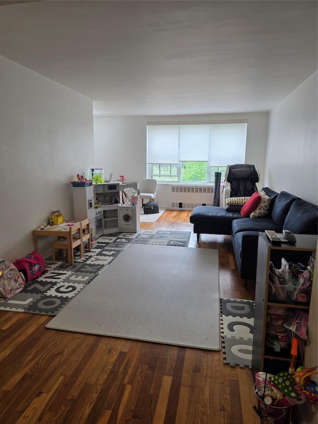 18-50 211th St Unit 6C, Bayside, NY 11360 - living room with radiator and wood finished floors