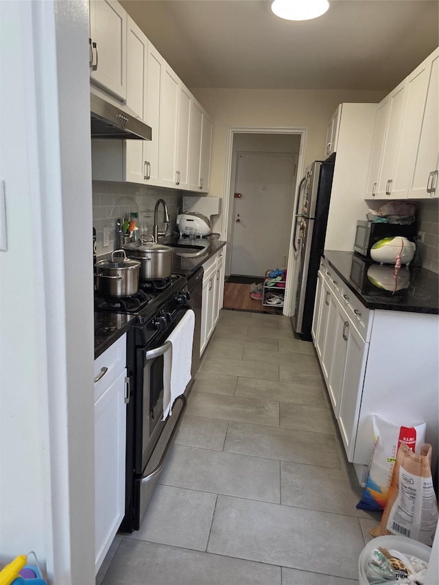18-50 211th St Unit 6C, Bayside, NY 11360 - kitchen featuring stainless steel appliances, under cabinet range hood, a sink, and dark countertops