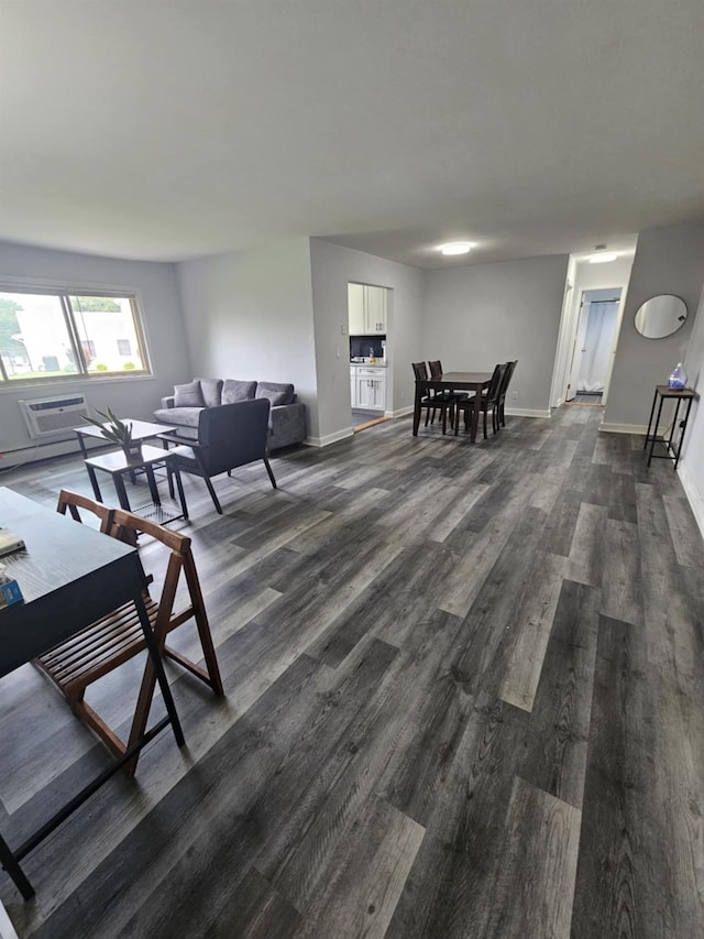 2445 Union Blvd Unit 7A, Islip, NY 11751 - living area featuring dark wood-type flooring, an AC wall unit, and a baseboard radiator