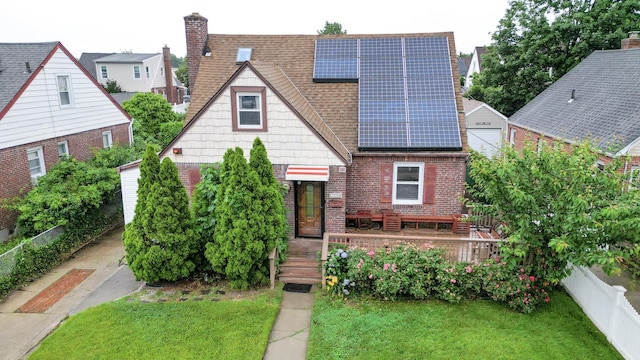 1078 Hancock Ave, Franklin Square, NY 11010 - view of front of home with a shingled roof, solar panels, brick siding, and a chimney