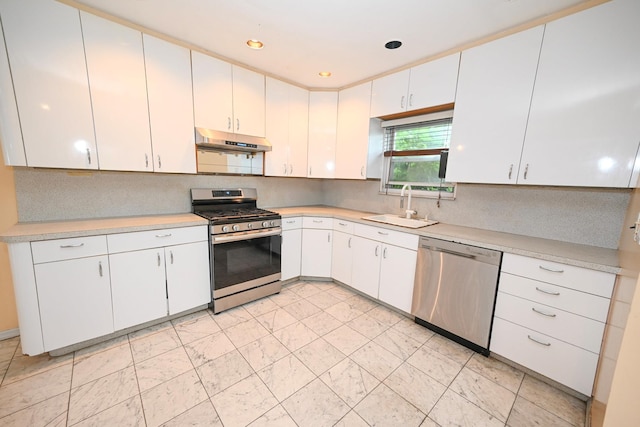 1078 Hancock Ave, Franklin Square, NY 11010 - kitchen with appliances with stainless steel finishes, under cabinet range hood, light countertops, white cabinetry, and recessed lighting