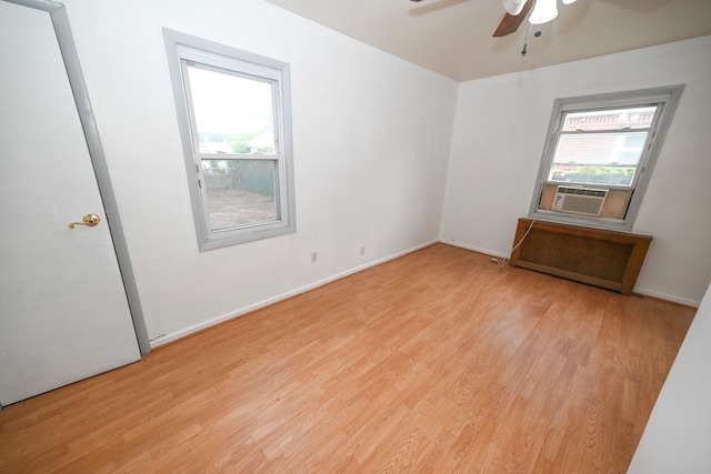 1078 Hancock Ave, Franklin Square, NY 11010 - empty room featuring radiator heating unit, ceiling fan, and wood finished floors