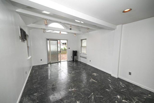 1078 Hancock Ave, Franklin Square, NY 11010 - empty room featuring radiator, beam ceiling, and stone finish flooring