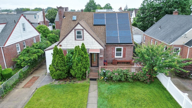 1078 Hancock Ave, Franklin Square, NY 11010 - view of front of property with solar panels, a fenced backyard, brick siding, and a shingled roof