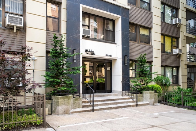 98-40 64th Ave Unit 1B, Rego Park, NY 11374 - entrance to property featuring cooling unit and stucco siding