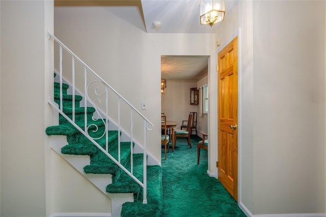 17 Shady Ln, Scarsdale, NY 10583 - staircase featuring a chandelier and carpet floors