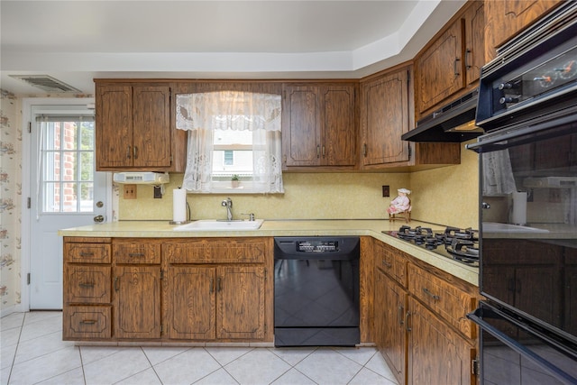 17 Shady Ln, Scarsdale, NY 10583 - kitchen with black appliances, under cabinet range hood, light countertops, light tile patterned flooring, and brown cabinetry