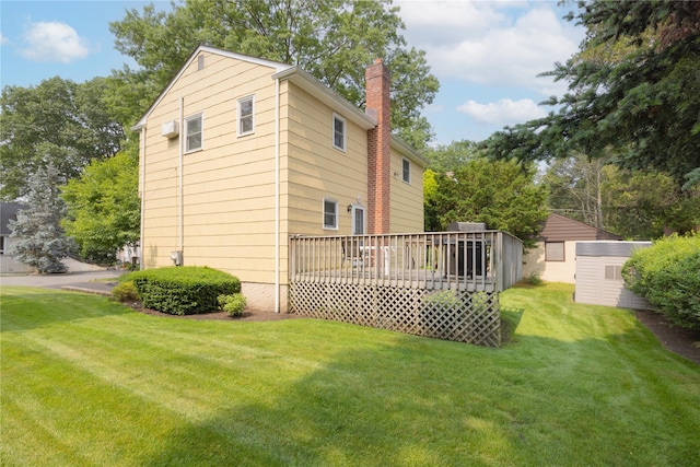 17 Shady Ln, Scarsdale, NY 10583 - view of side of home featuring a chimney, a shed, a deck, a yard, and an AC wall unit