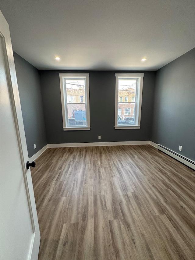 1140 Sutter Ave, Brooklyn, NY 11208 - spare room with wood finished floors, baseboard heating, healthy amount of natural light, and recessed lighting