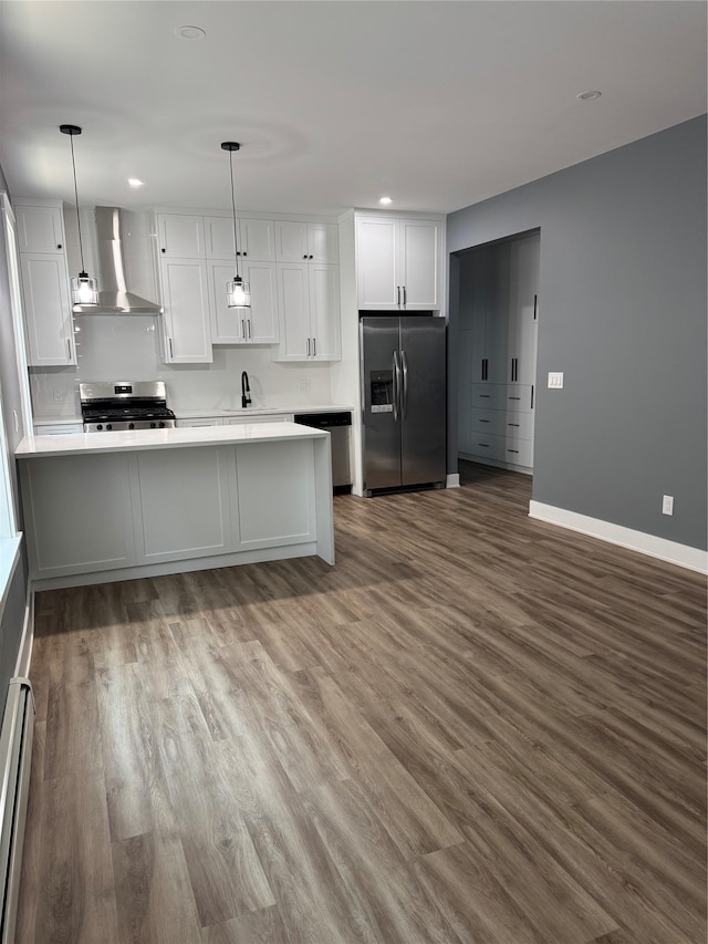 1140 Sutter Ave, Brooklyn, NY 11208 - kitchen with wall chimney exhaust hood, appliances with stainless steel finishes, white cabinets, dark wood-style flooring, and recessed lighting