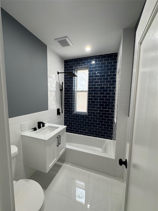 1140 Sutter Ave, Brooklyn, NY 11208 - bathroom with vanity, tile walls, washtub / shower combination, and tile patterned floors