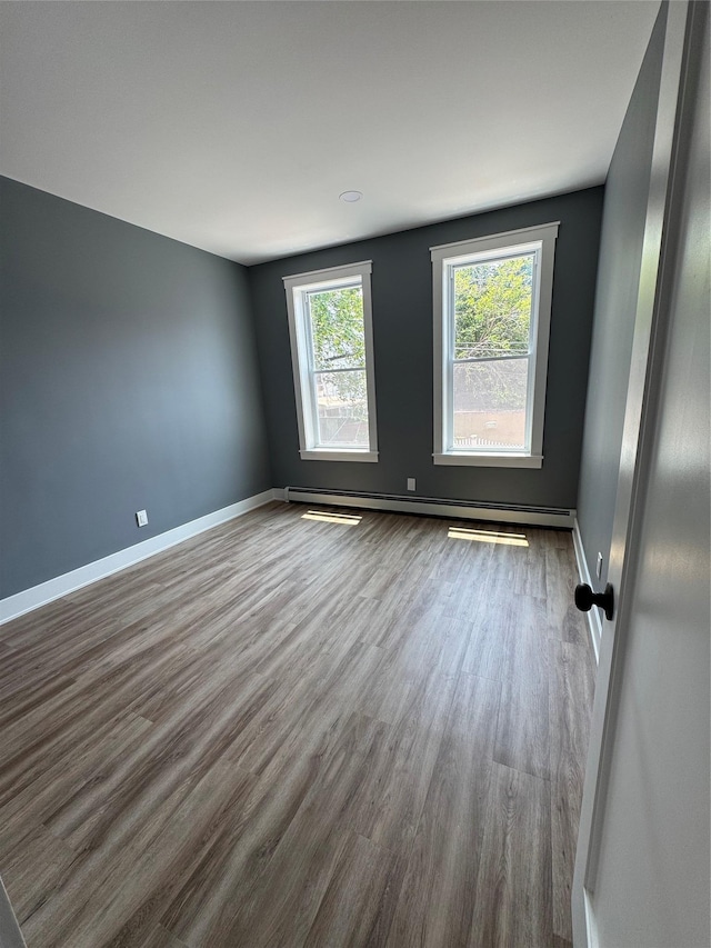 1140 Sutter Ave, Brooklyn, NY 11208 - spare room with wood finished floors and baseboard heating