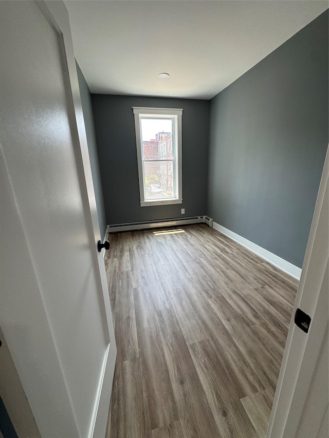 1140 Sutter Ave, Brooklyn, NY 11208 - spare room featuring wood finished floors and baseboard heating