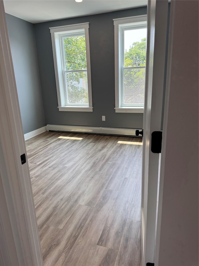 1140 Sutter Ave, Brooklyn, NY 11208 - spare room featuring wood finished floors and a baseboard heating unit
