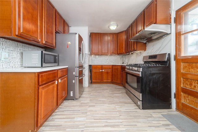 67-15 214th St, Bayside, NY 11364 - kitchen with stainless steel appliances, extractor fan, light wood-style flooring, tasteful backsplash, and light countertops