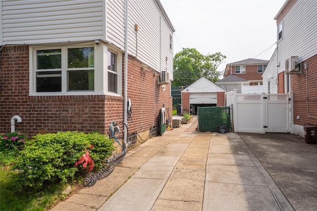 67-15 214th St, Bayside, NY 11364 - view of side of home with brick siding and a patio area